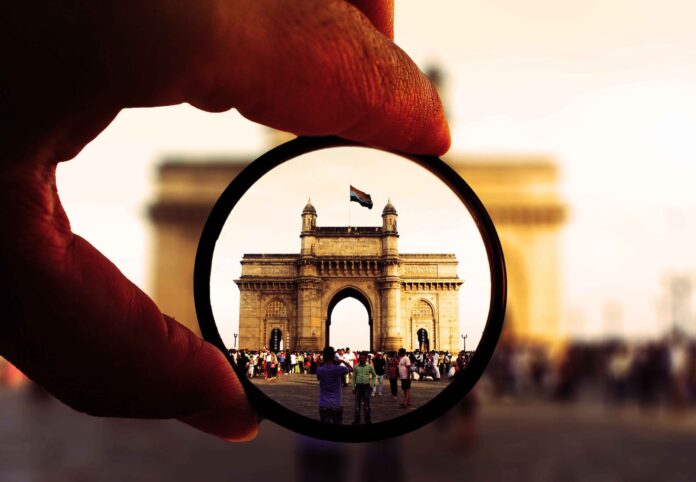 person holding round glasses in shallow photo